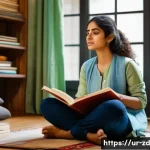 Home 21 자기계발서 추천과 활용법 - A thoughtful young South Asian woman sitting cross-legged on a cozy floor cushion in a softly lit ro...